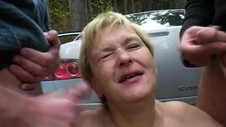 Old mature blonde is giving handjob to lucky dude