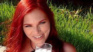 Redhead Devyn Lux enjoys while sucking a dick outdoors in a park