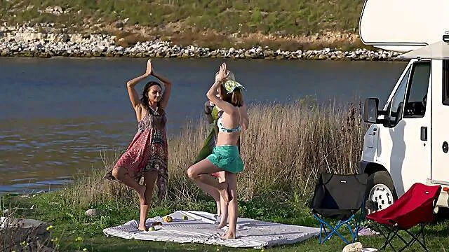 Sensual girls share romantic outdoor threesome moments by the lake