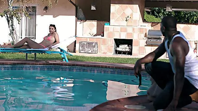 Passionate doll devours whole BBC by the pool in addictive interracial