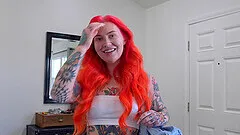 Tattooed redhead Loveless shows her round butt while posing