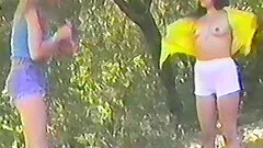 Outdoors video of two naughty babes having sex with a double sided toy