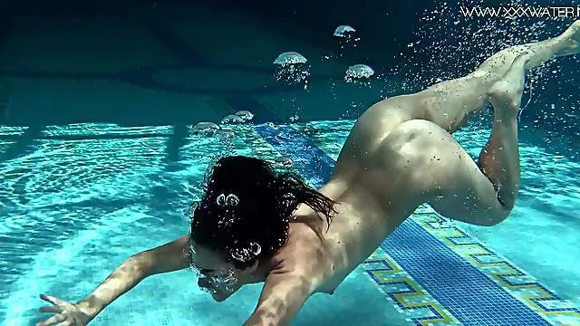 Small tits and a shaved pussy on a nude swimming sweetheart