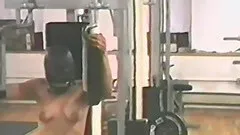 Kinky masked dude gets fucked with a strap on in the gym