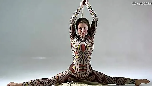 Flexible beauty in a bodysuit dances and strips