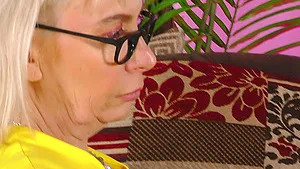 Blonde mature Barby with glasses spreads legs to pleasure her cunt