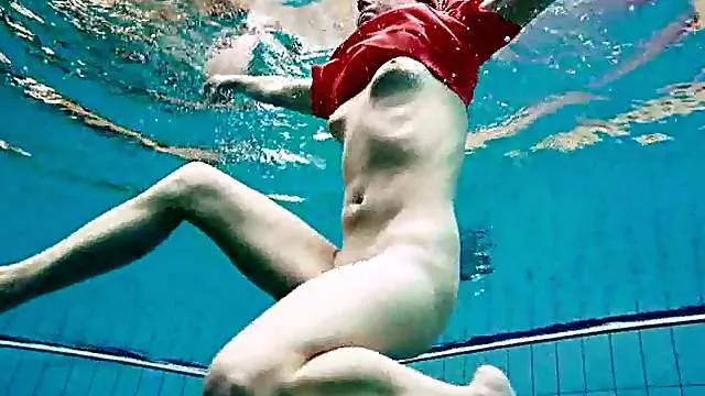 Babe swimming in a red dress takes it off underwater