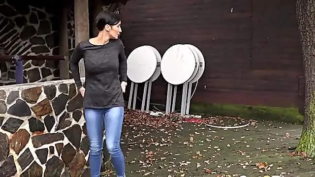 Short hair babe goes pee in a public place