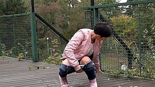 Short hair cutie in a sweater takes a public piss