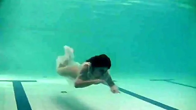 Sheer white dress on a teen swimming in the pool