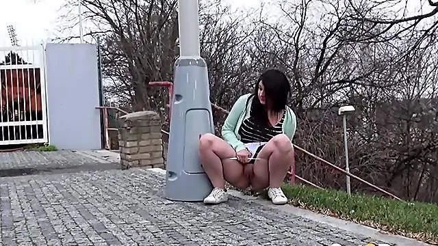 Curvy babe on a walk pissing in public