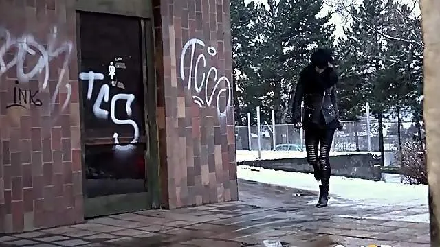 Fashionable babe in a leather jacket pees in public
