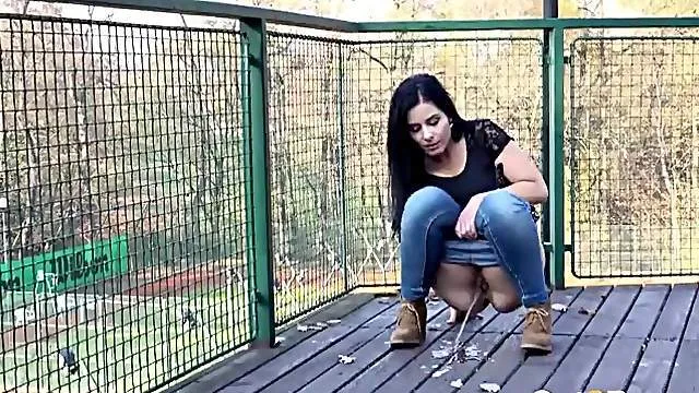 Busty babe pissing in public