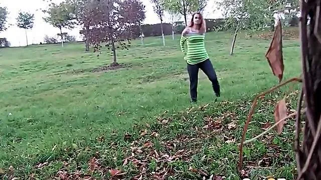 Watch a cute girl piss in a grassy field
