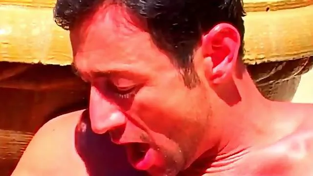 Muscular gay guys swallow dick in a fountain