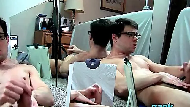 Young guy in glasses strokes and licks his cum
