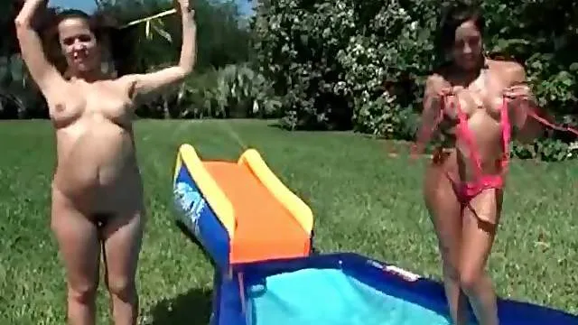 Bikini girls strip naked and play in the water