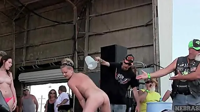 Topless ladies get wet in a public stage show