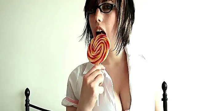 Schoolgirl in nerdy glasses does a striptease