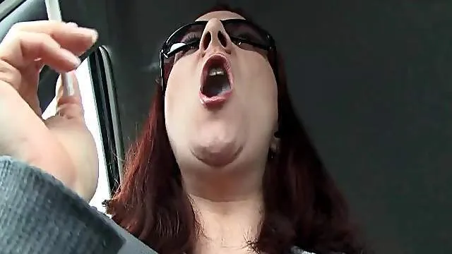 Redhead lights up in the car and smokes