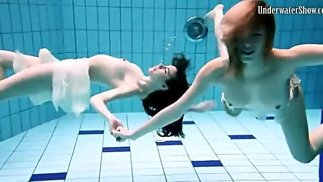 Nearly naked girls go swimming in the pool