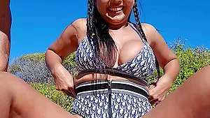 Busty MILF servicing boyfriends at a beach