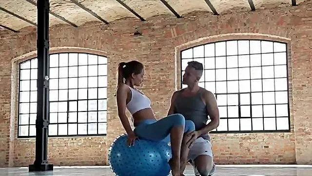 Sporty girl in skintight pants teases him