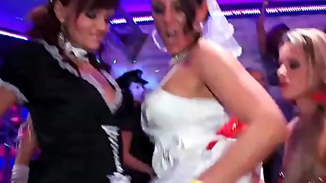 Costume party at night club with dancing girls
