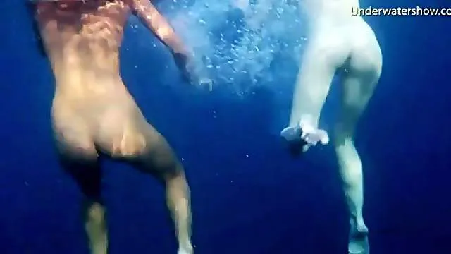 See lean naked bodies underwater in ocean