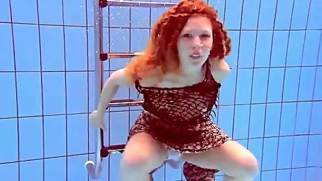 Underwater with a redheaded teen stripping