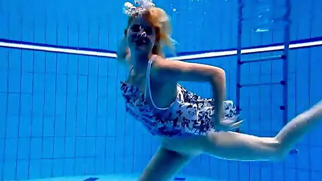 Adorable girl with small tits swims naked