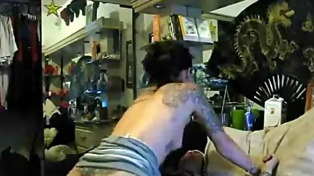 Heavily tattooed hottie has interracial sex