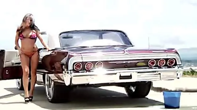 Girl gets soapy washing the car