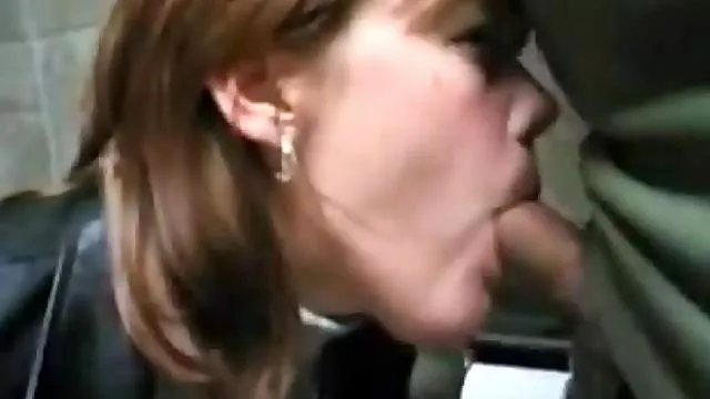 Naughty redhead sucks cock in public toilet