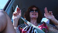 Horny mature slut Andi spreads her legs to masturbate in a car