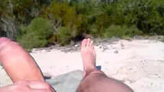 He's jerking off on the beach