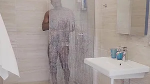 Lady Masha enjoys while sucking a big black cock in the shower