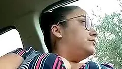 Busty woman in glasses masturbates in car