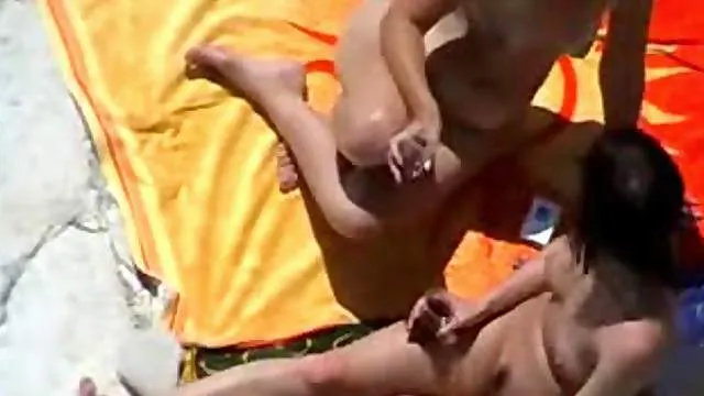 Two couples fool around on the beach