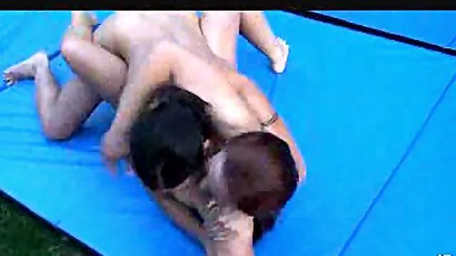 Hot wrestling girls on a mat outdoors