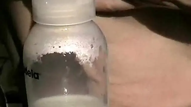 Lactating girl pumps her breast milk