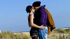 Kenza gets wet while playing with her friend at the beach.