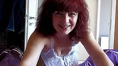 Incredible redhead mom sucks and penetrates herself in a couple of different positions.