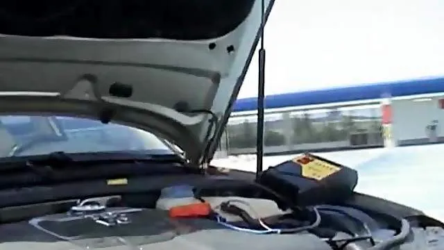 Busty babe stripping on her car