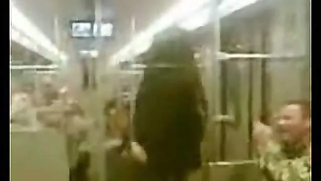 Chick stripping on a public subway