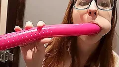 Lady with glasses plays with a dildo.