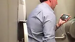 Stranger man in a public toilet filmed on a hidden camera