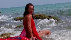 Horny babe moans in pleasure while her man is drilling her at the beach.