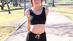 Sporty redhead babe Sabina strips and stretches outdoors