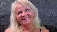 Smiling mature blonde granny plays with toys before riding a fat dick